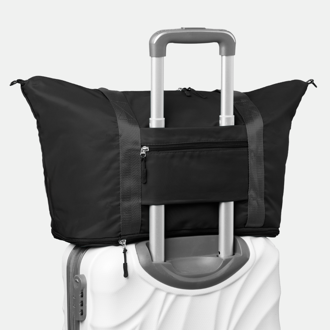 black travel tote bag with luggage sleeve The Foldie® Travel Bag